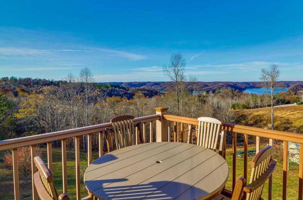 a wooden table and chairs on a deck with a view at Byrdstown Apartment Less Than 4 Mi to Dale Hollow Lake! in Frogue