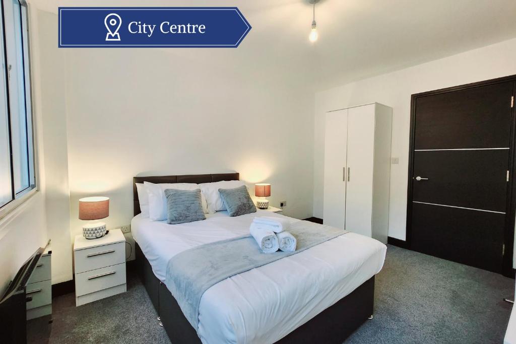 a bedroom with a large bed with two towels on it at Remarkable 1Bed Apartment in Central Liverpool in Liverpool