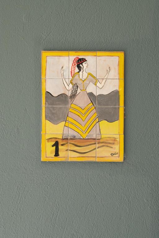 a painting of a woman in a dress on a wall at CORAL in Parga