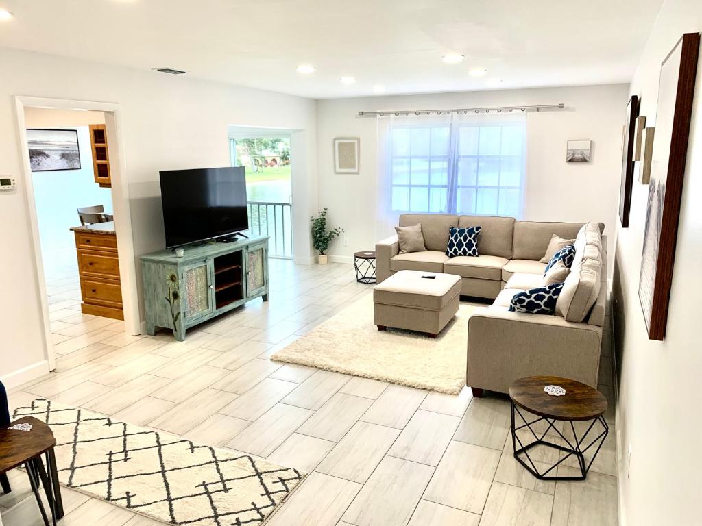 a living room with a couch and a flat screen tv at Newly remodeled 2br, 2ba condo in Naples Bath and Tennis in Naples