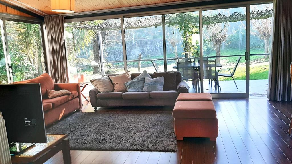 a living room with a couch and a table at 7 bedrooms villa with private pool enclosed garden and wifi at Povoa de Lanhoso in Póvoa de Lanhoso