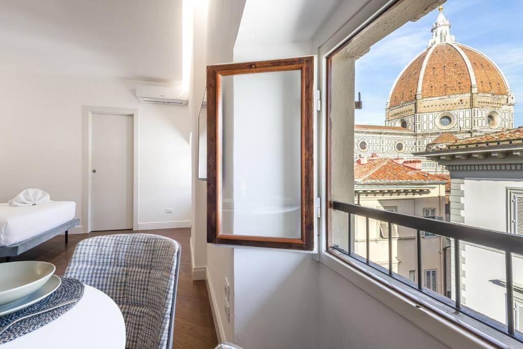 a room with a window with a view of a building at UNYCA - Duomo Luxury View Florence in Florence