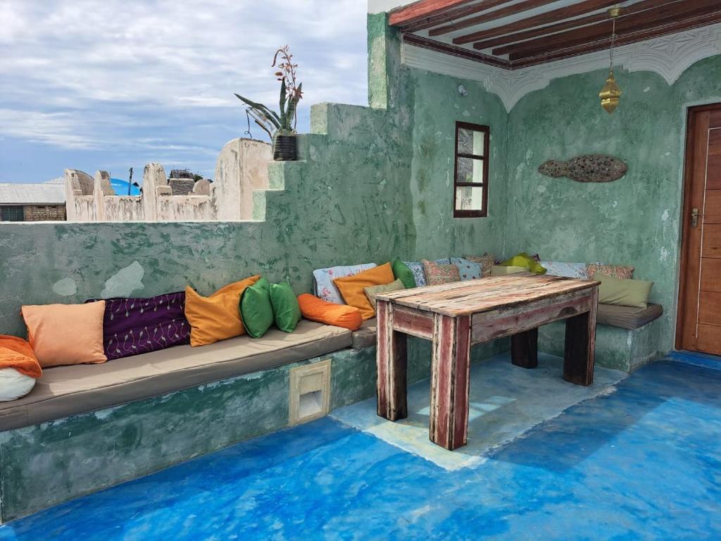 a living room with a couch and a table at Pwani House - Lamu Seafront in Lamu