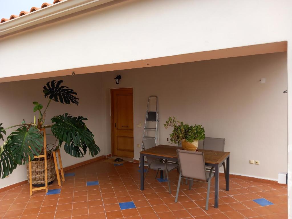 a dining room with a table and some plants at Pavlos Loft - Garden Views & Terrace in Leontari in Leondárion