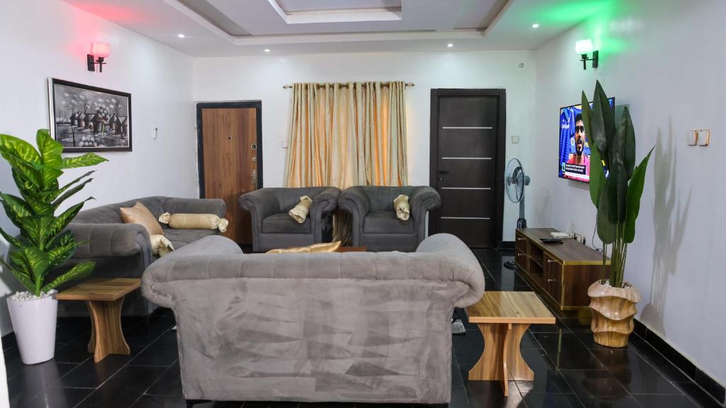 a living room with a couch and a table at BOL LODGE AND APARTMENT in Lagos