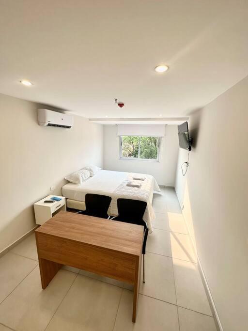 um quarto com uma cama e uma mesa em Hermoso Loft en Asuncion E4 em Assunção