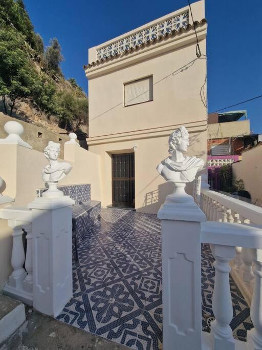 a building with two statues in front of it at Casa Pagan in Cullera