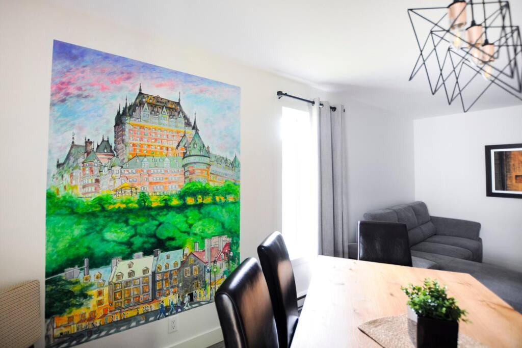 a dining room with a painting on the wall at Confo28 Chute Montmorency Parking in Quebec City
