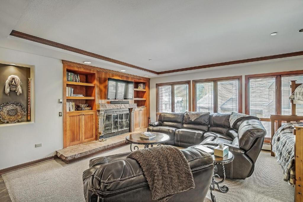 a living room with a couch and a tv at Slopeside Retreat - Ski In Ski Out - Beaver Creek in Beaver Creek