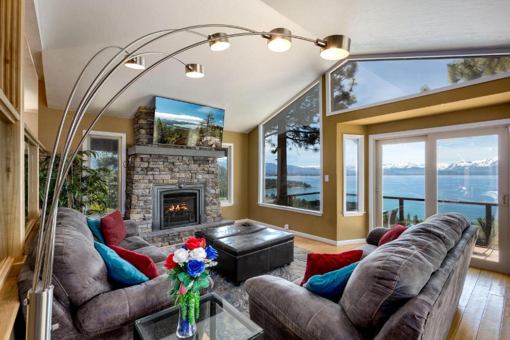 a living room with couches and a fireplace at Tahoe Lakescape in Zephyr Cove