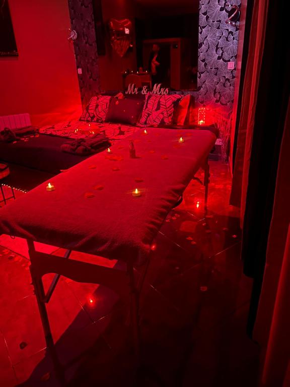 a red room with a table with lights on it at HomeSparadise Loveroom in Besançon