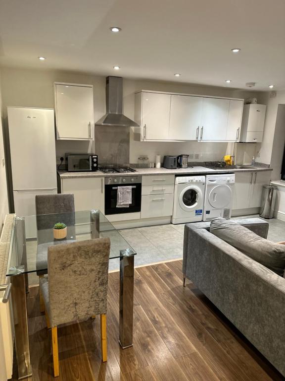 a kitchen with a glass table and a couch in it at Hoxton Street, Shoreditch in London