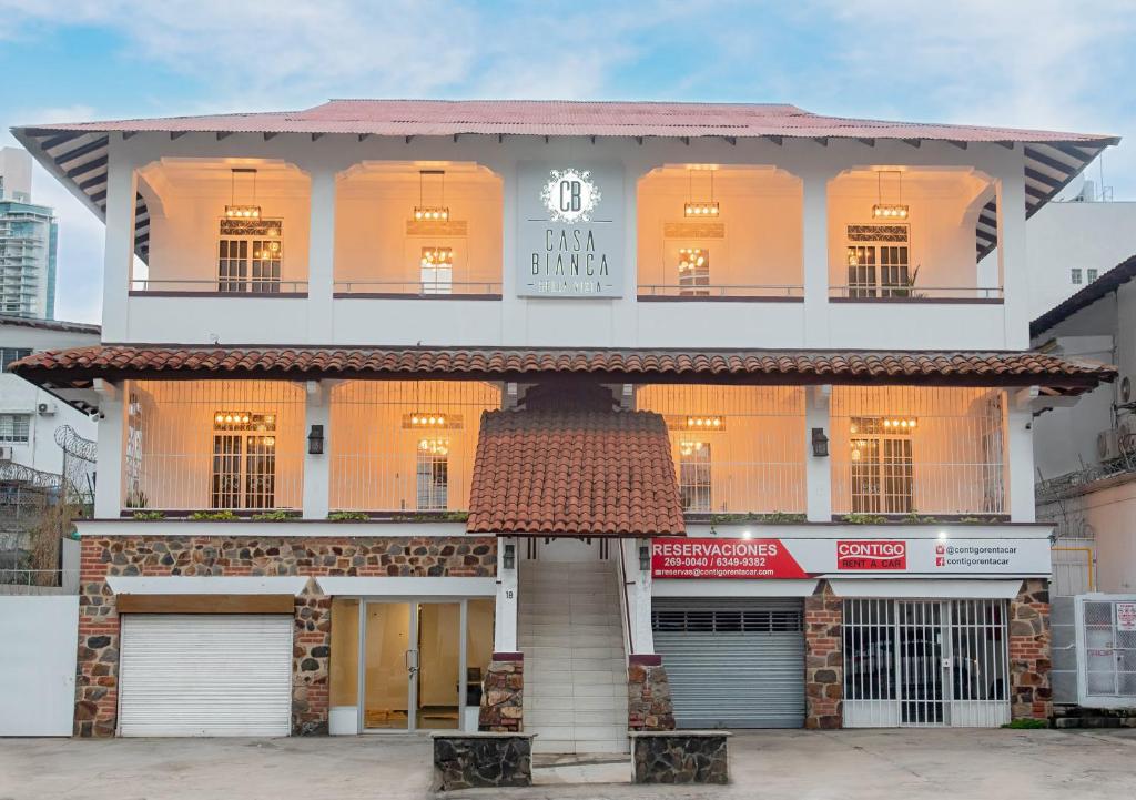 a large white building with a store front at CASA BIANCA Bella Vista in Panama City