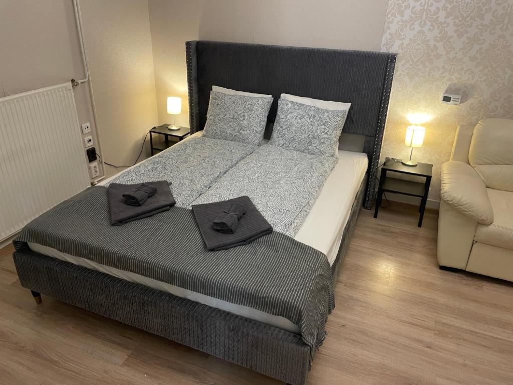 a bedroom with a large bed with two trays on it at Cozy apartment on Raday Corso in Budapest