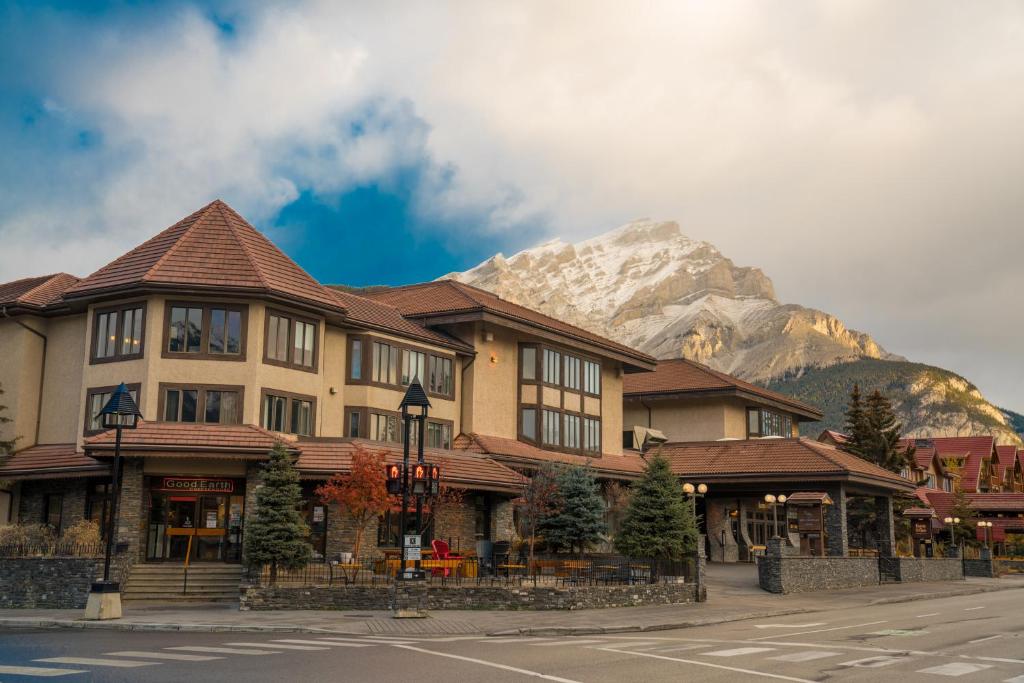a large building with a mountain in the background at Elk + Avenue Hotel in Banff