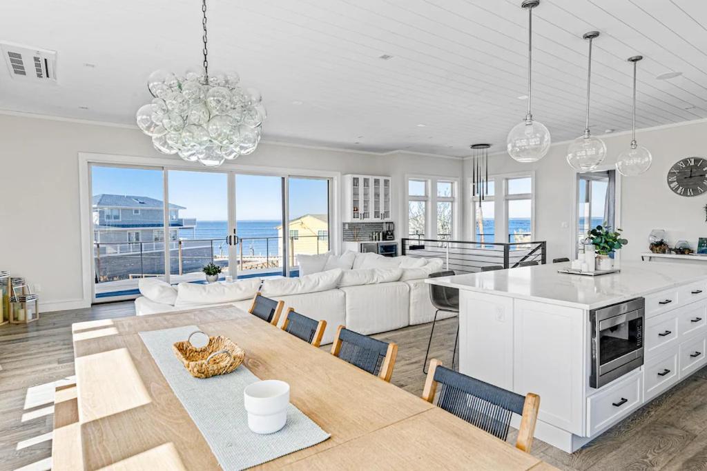 a kitchen and living room with a view of the ocean at Fire Island White House - Ocean Bay Park, NY in Ocean Beach