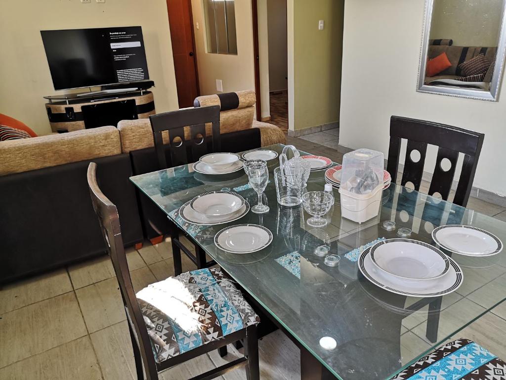 uma mesa de jantar com pratos e copos em El Amanecer 2.0 em Abancay