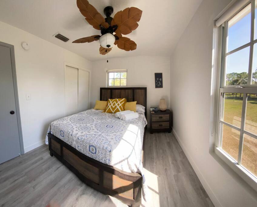 a bedroom with a bed and a ceiling fan at Rancho Alegre. Bring your boat and RV too! in Clewiston