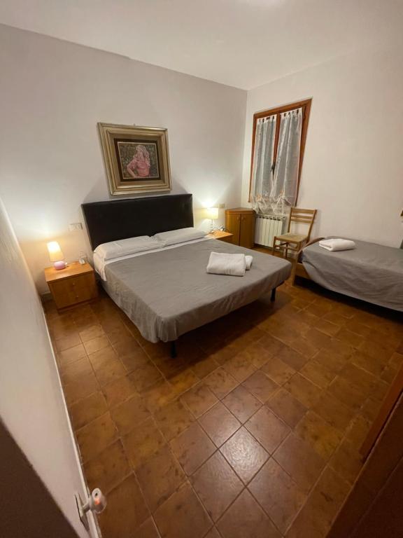 a bedroom with a bed and a table and chairs at Maison d'Ax Venice Center in Venice