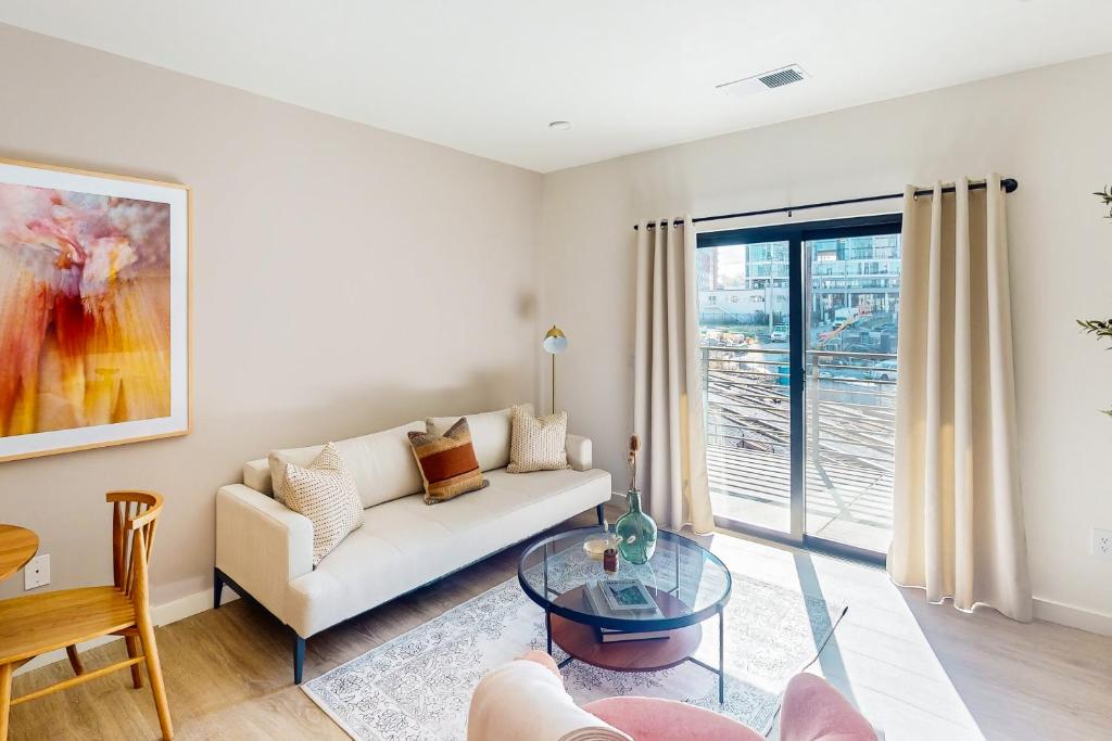 a living room with a couch and a glass table at Life of the Party, Unit #418 in Nashville