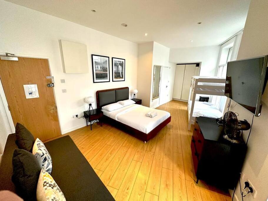 een grote kamer met een bed en een bank bij V05 Fantastic Apartment - Piccadilly Circus on Doorstep! in Londen