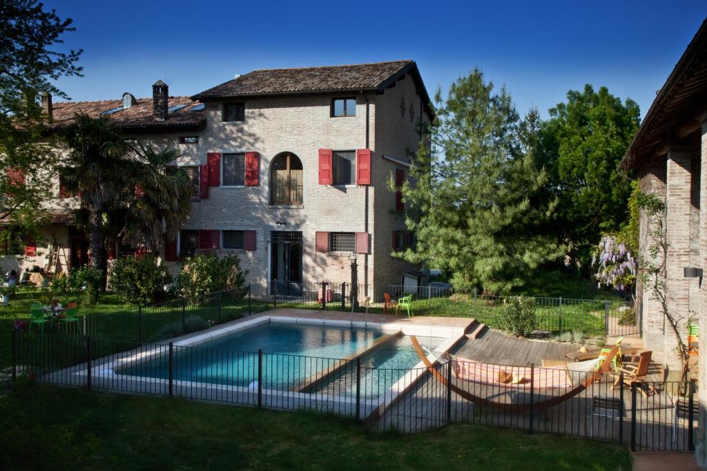 a swimming pool in front of a house at La Lepre Bianca in Cento