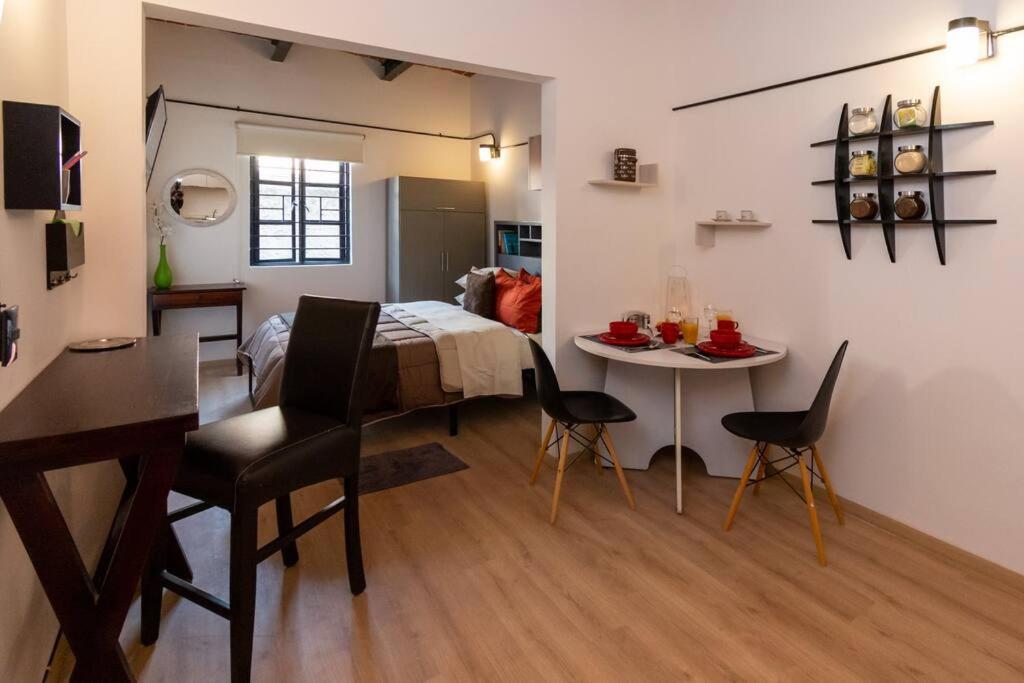 a room with a table and a dining room at Encantadora Suite con Roof Garden en Roma Nte. in Mexico City