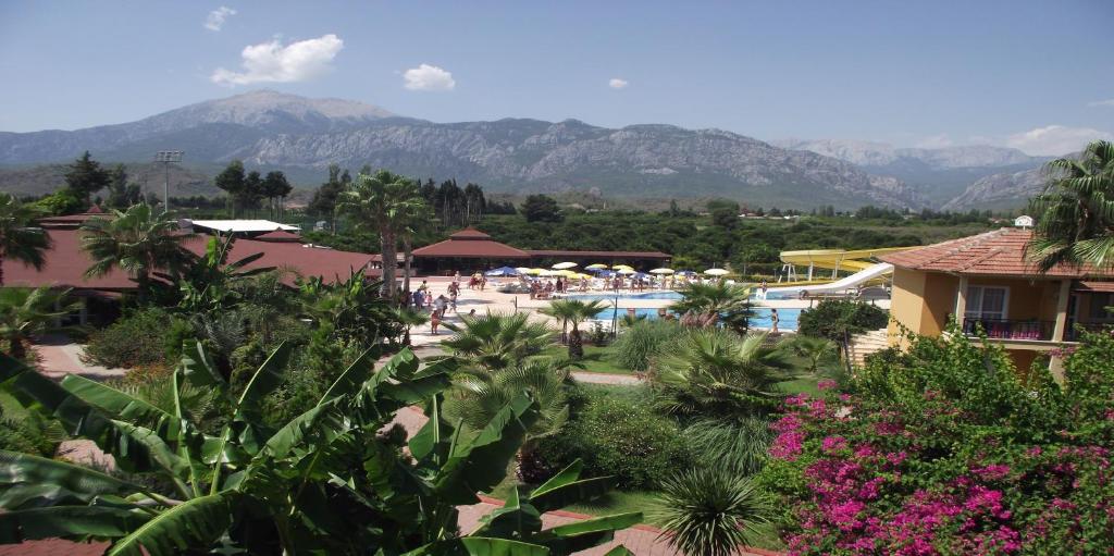 a resort with a pool and mountains in the background at MIR'AMOR GARDEN Resort Hotel-ALL INCLUSIVE in Antalya