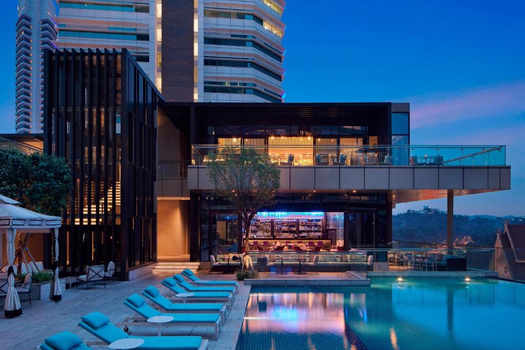 a hotel with a swimming pool and a building at The St. Regis Kuala Lumpur in Kuala Lumpur