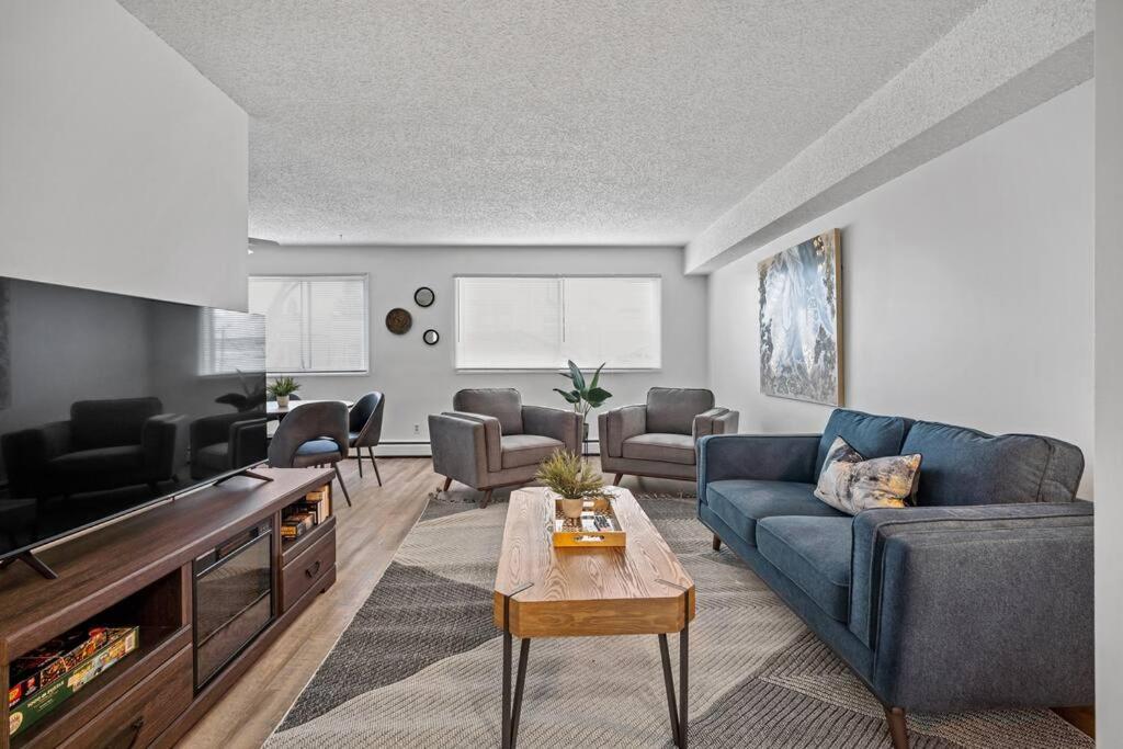 a living room with a couch and a table at Modern 2BR with Free Parking and Newly Renovated in Fort McMurray