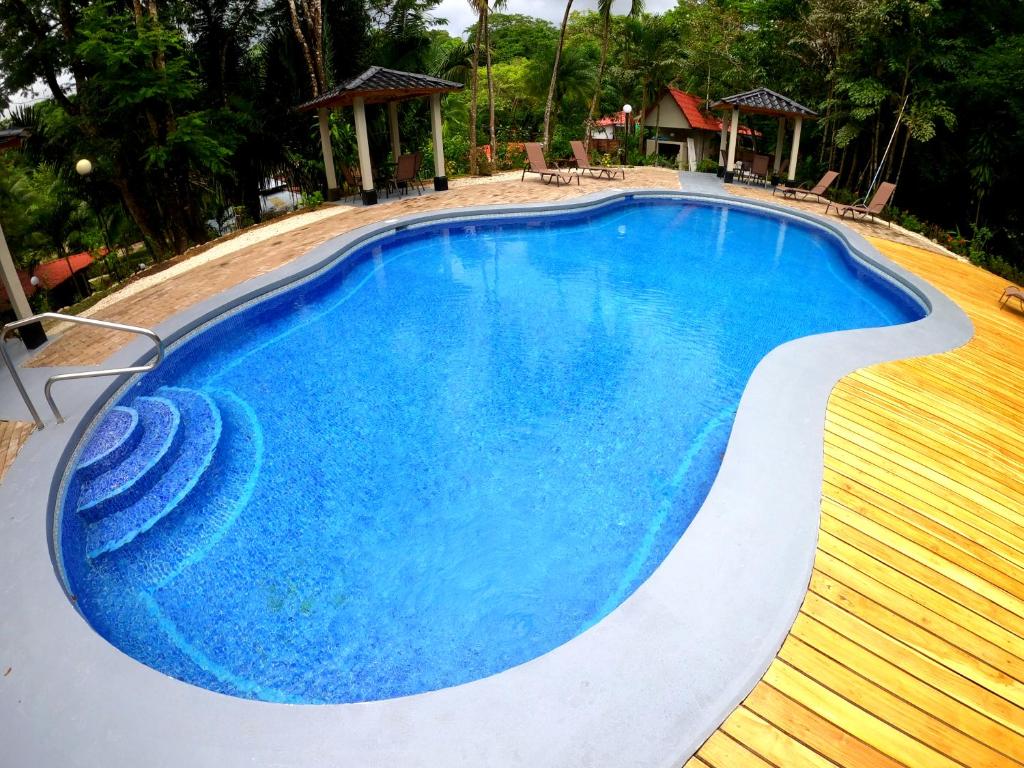 una piscina de agua azul en un complejo en El Sueno Tropical Hotel, en Carrillo
