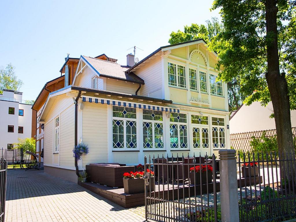 a house with a fence in front of it at Aparte Lux in Jūrmala