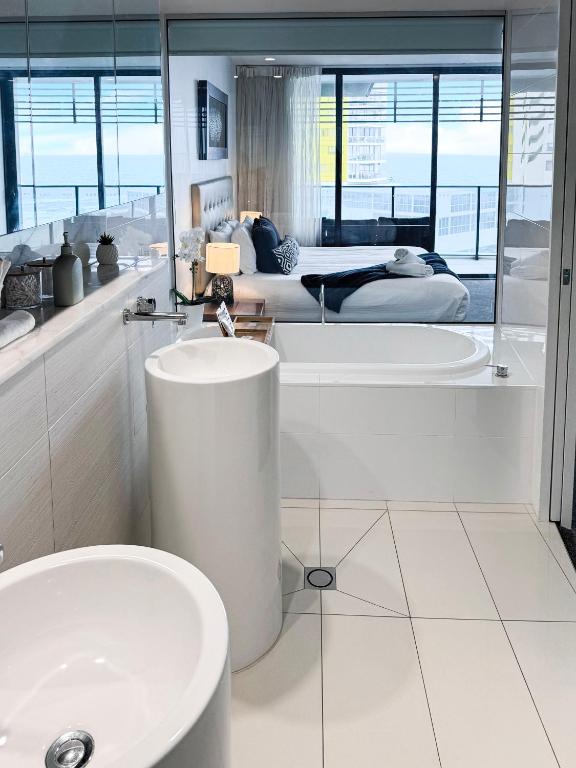 a bathroom with a sink and a tub and a toilet at Oracle 11th floor Tower 1 - GC Getaways in Gold Coast