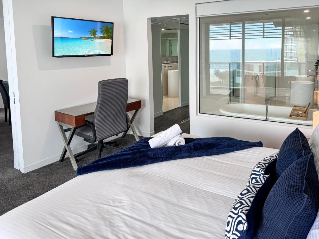 a bedroom with a bed and a desk and a television at Oracle 11th floor Tower 1 - GC Getaways in Gold Coast