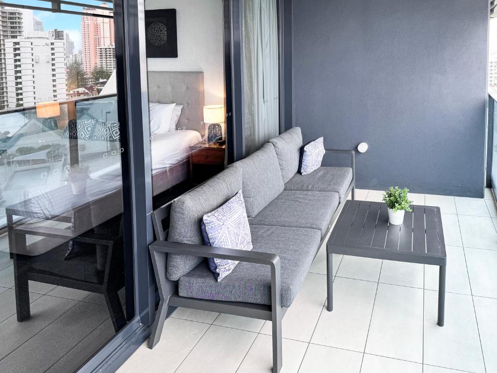 a living room with a couch and a table and a bed at Oracle 11th floor Tower 1 - GC Getaways in Gold Coast