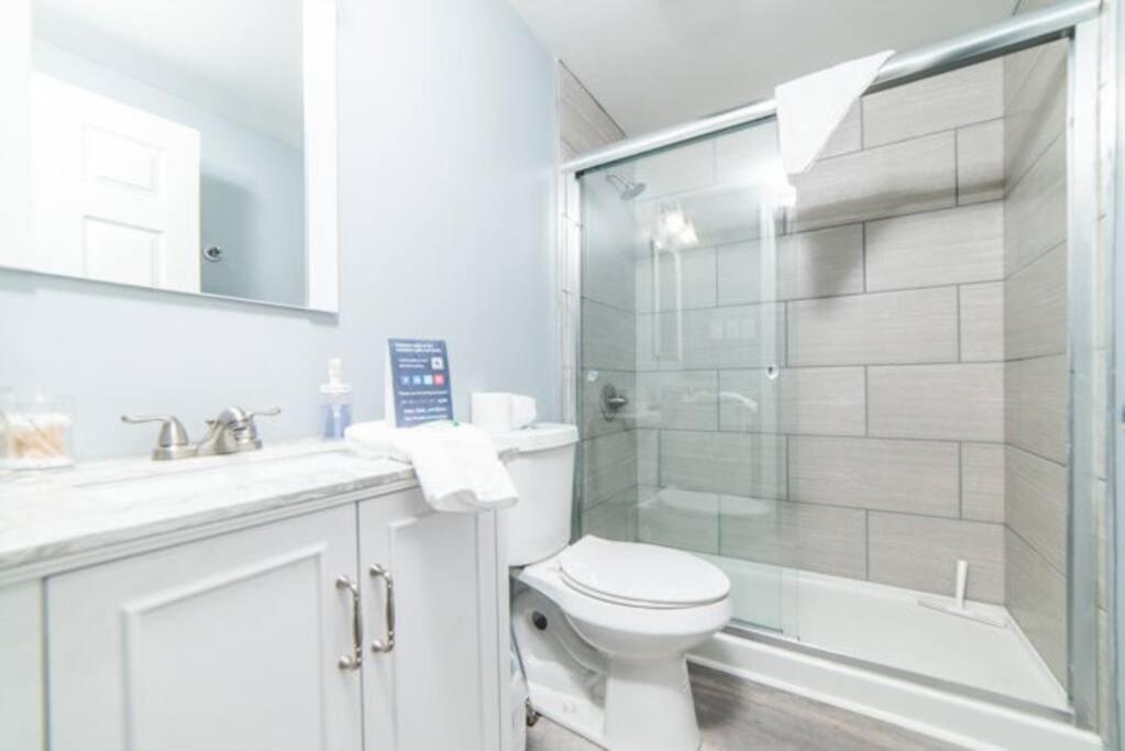 a white bathroom with a toilet and a shower at 1st Floor - Free Parking - Washer & Dryer - AGH in Pittsburgh