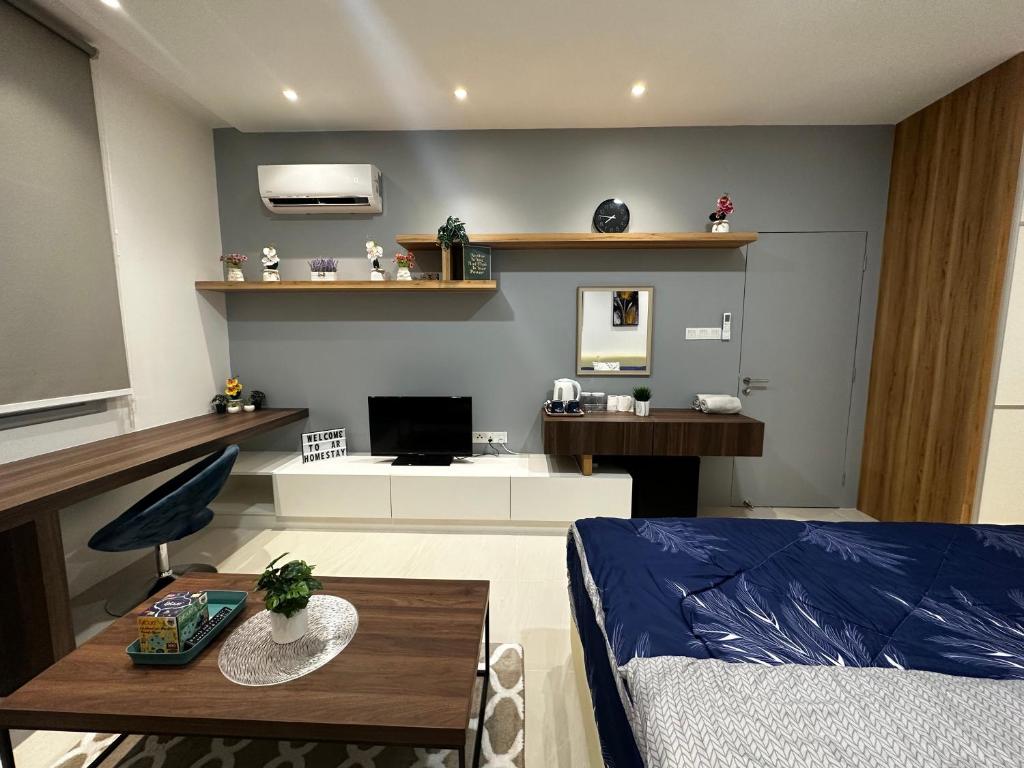 a living room with a bed and a table at A.R Homestay Riverine Diamond in Kuching