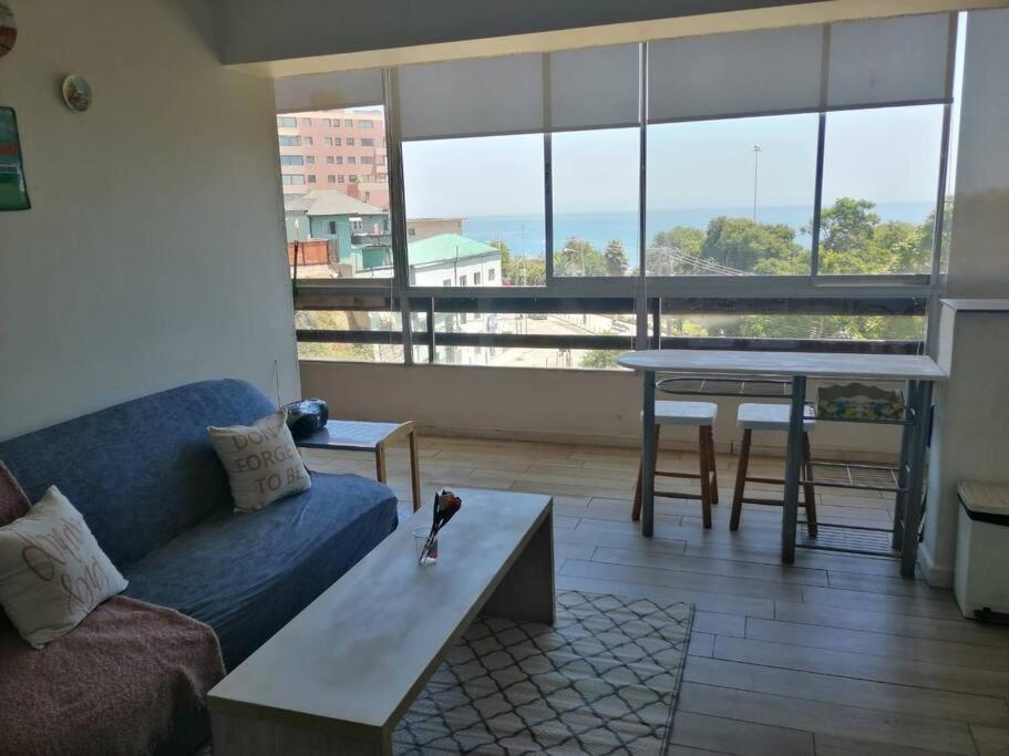 een woonkamer met een bank en een tafel bij Espectacular vista y central in Viña del Mar