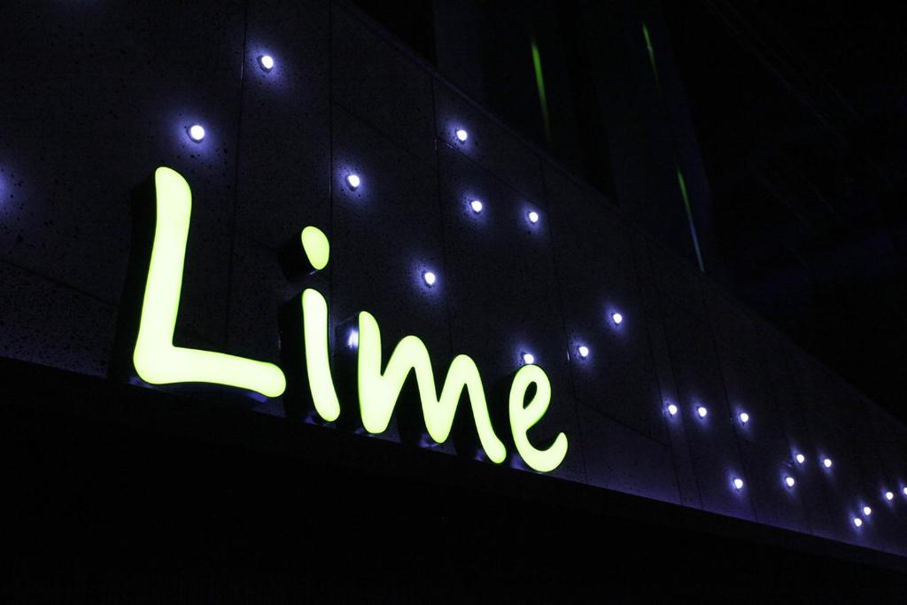 a neon sign that says l time on top of a building at Lime hotel in Suwon