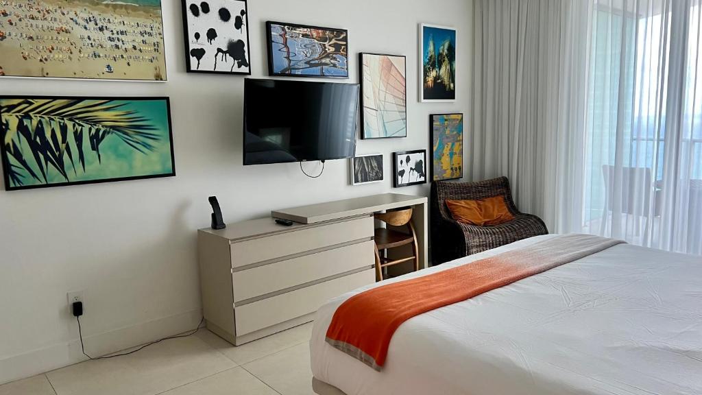1 dormitorio con 1 cama y TV en la pared en Luxury apartment with an amazing view - Daily resort fee and parking not included-, en Hollywood