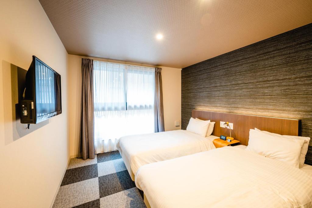 Postel nebo postele na pokoji v ubytování HOTEL THE POINT Kiyomizu Gojo