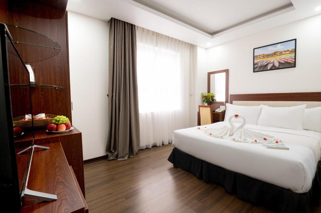 Postel nebo postele na pokoji v ubytování Dao Ngoc Hotel Da Nang