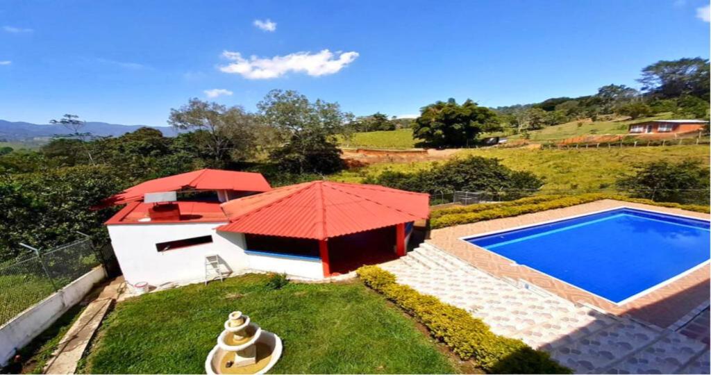 an image of a swimming pool with a red roof at Casa Finca Kilometro 28 Bitaco in La Cumbre