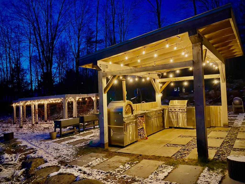 a gazebo with lights on it at night at Le Camp Caché Shefford in Shefford