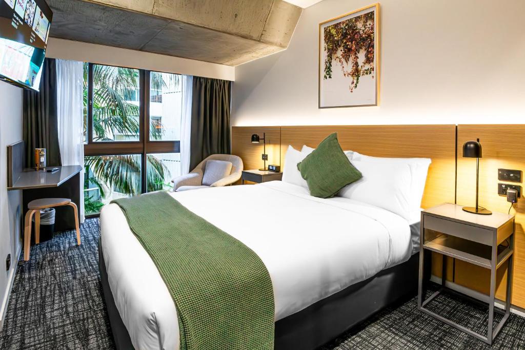 a hotel room with a large bed and a window at Song Hotel Sydney in Sydney
