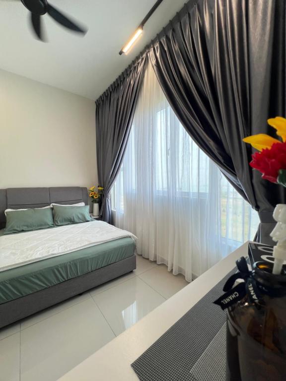 a bedroom with a bed and a large window at Melaka AmberCove Homely Seaview 2R2B in Malacca