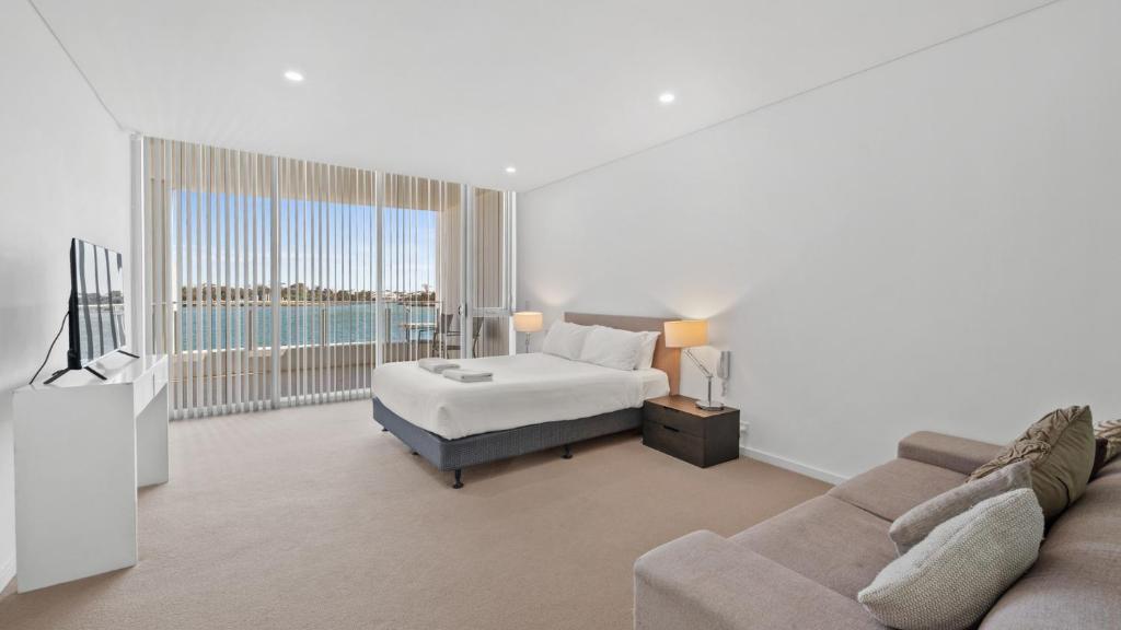 a living room with a bed and a couch at Seapoint 109 in Mandurah