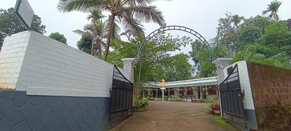 an entrance to a building with a gate at Pauls Retreat Wayanad in Wayanad