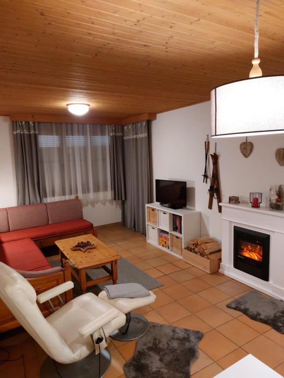 a living room with a couch and a fireplace at Apartment Gerlitzen Garden in Treffen