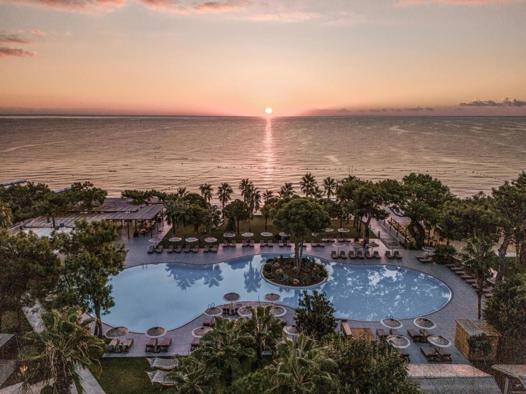 an aerial view of a resort with a pool and the ocean at Balmy Beach Resort Kemer in Kemer